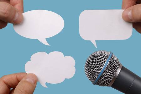 25636533-conference-interview-or-social-media-concept-with-microphone-and-blank-speech-bubbles